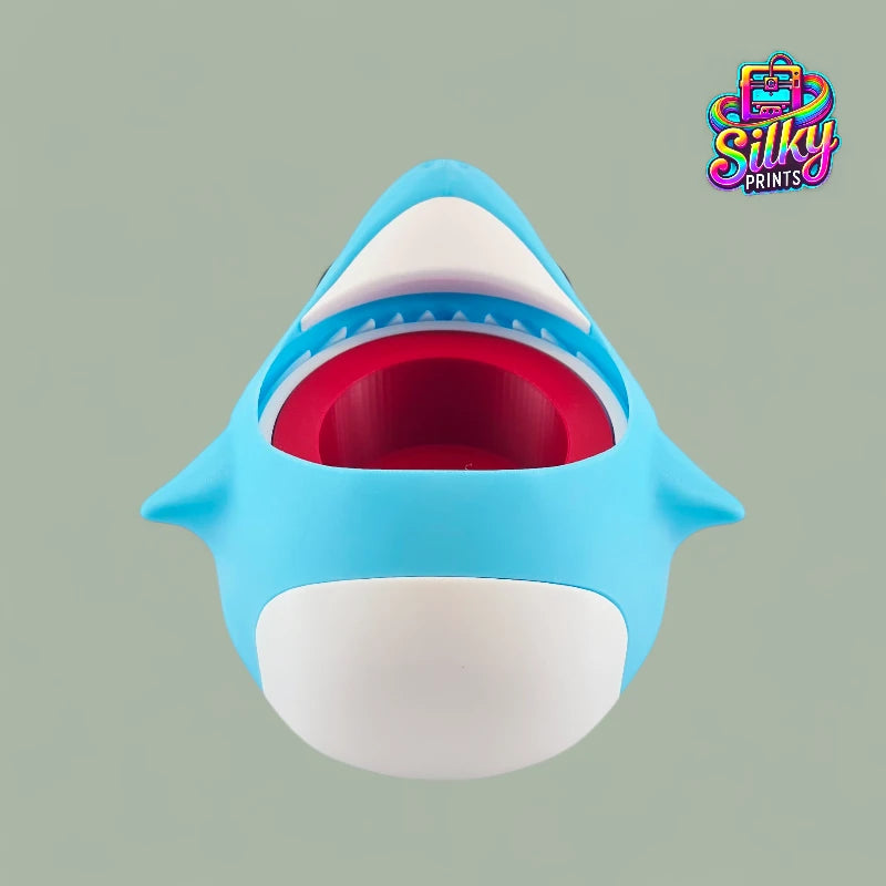 Blue shark-shaped container with a red interior on a gray background, featuring the Silky Prints logo.