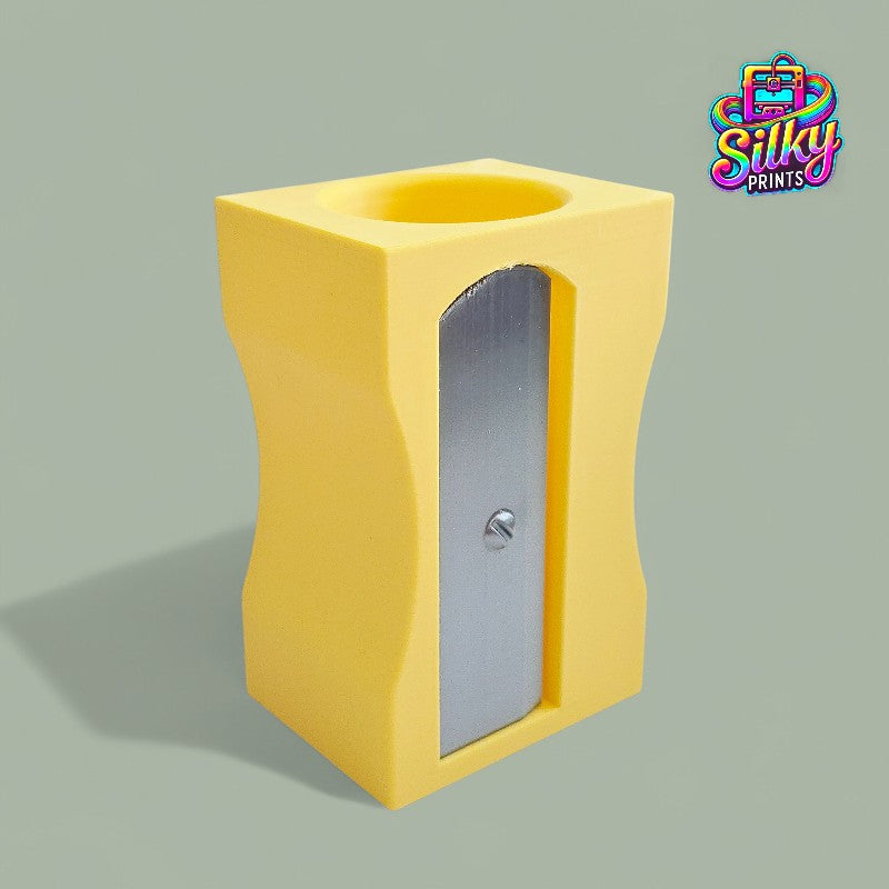 Yellow pencil sharpener on a gray background with 'Silky Prints' logo.